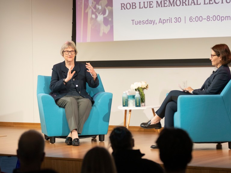 two people in conversation on stage