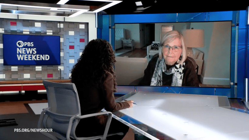 Joan Brugge speaking to PBS host Laura Barrón-López.