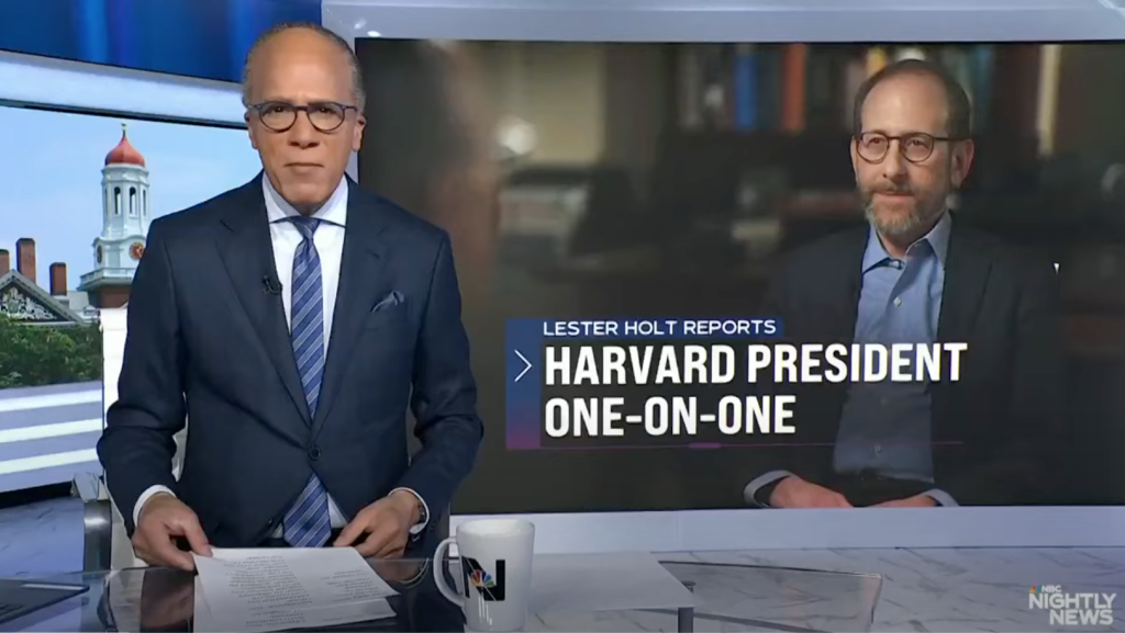 Lester Holt straight to camera with a photo of President Garber in the background.