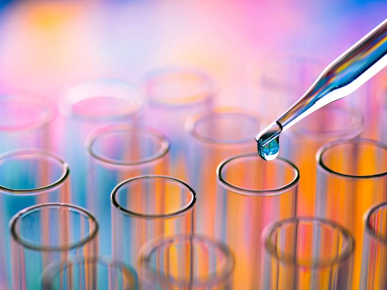 A dropper going into a test tube