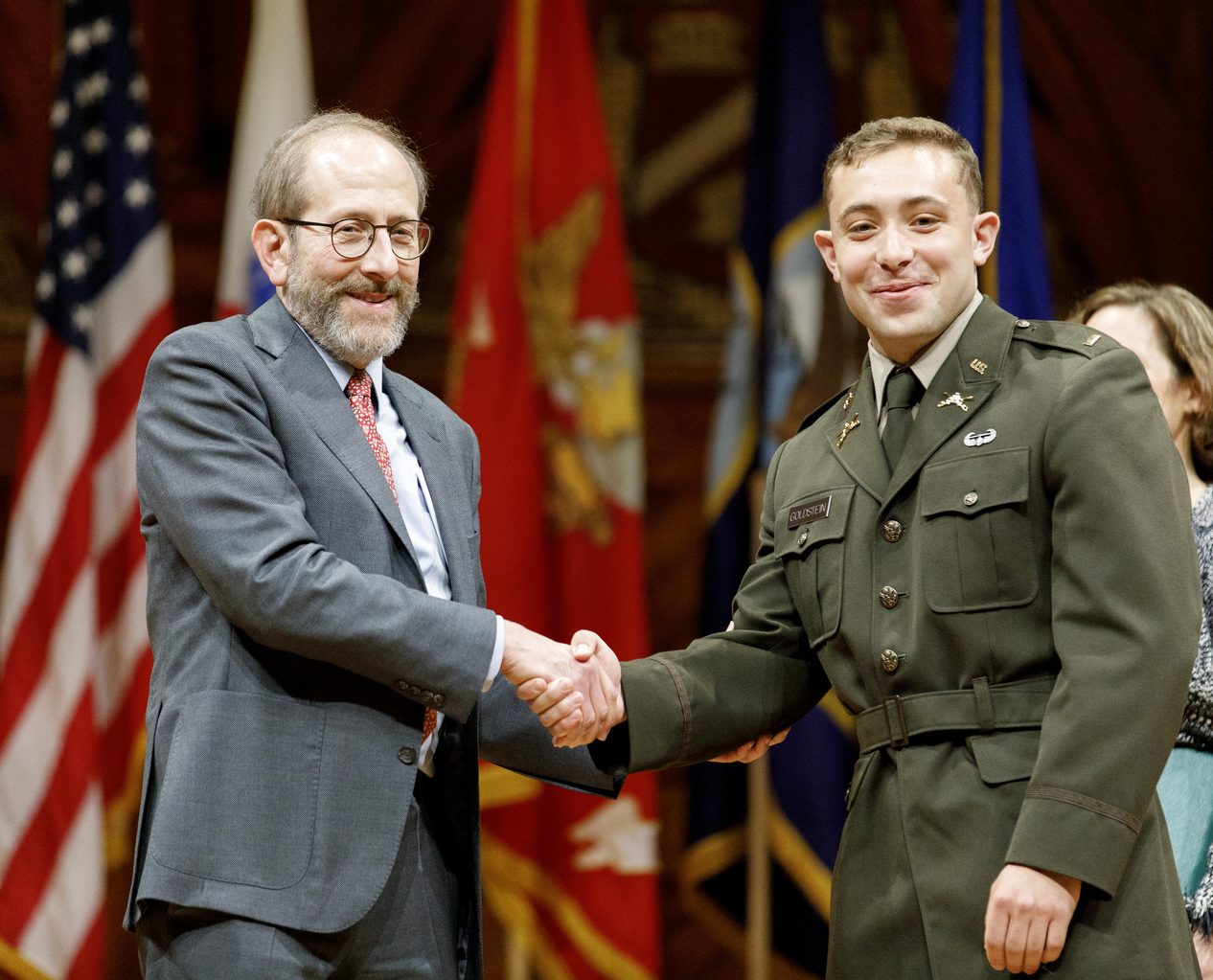 President Garber shakes the hand of an officer.
