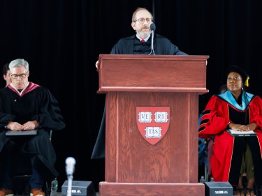 Alan Barber speaking at a podium.