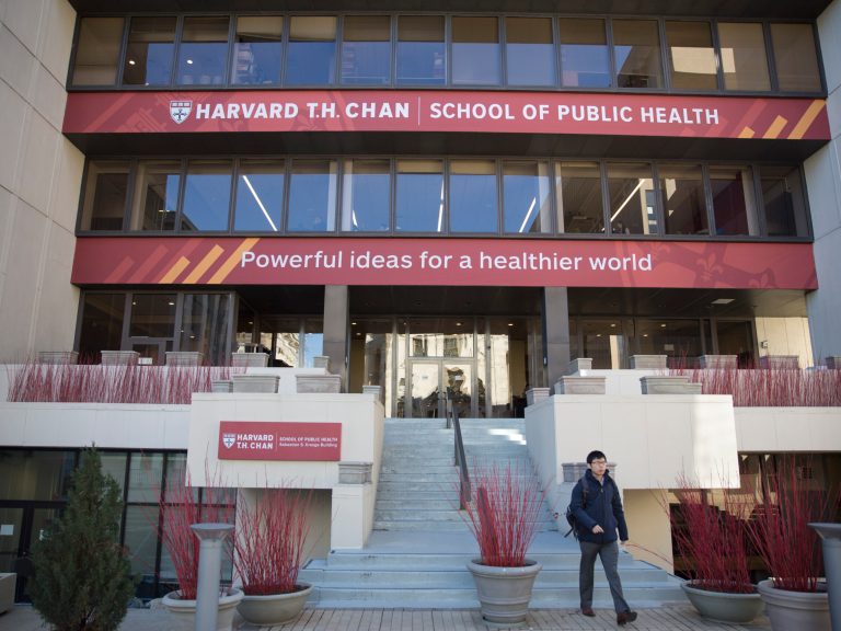 A man walking down steps on the public school campus