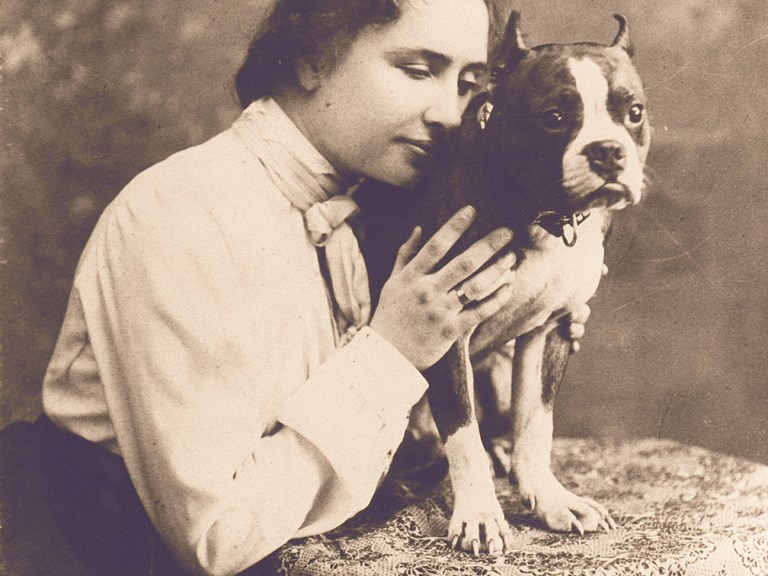 Helen Keller holding her dog