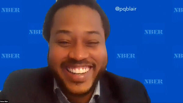 A man smiling on a zoom call