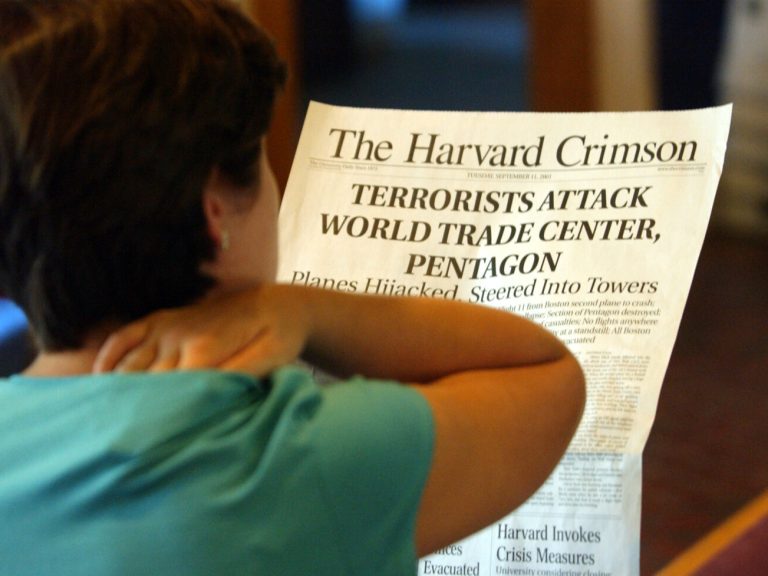 A woman reading a Harvard Crimson