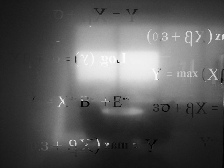 A glass wall with equations etched in it