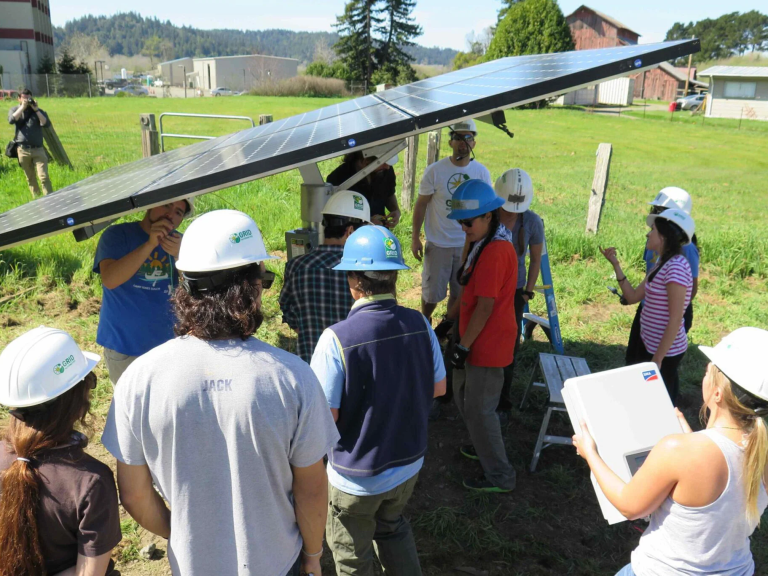 People working under a solar panel
