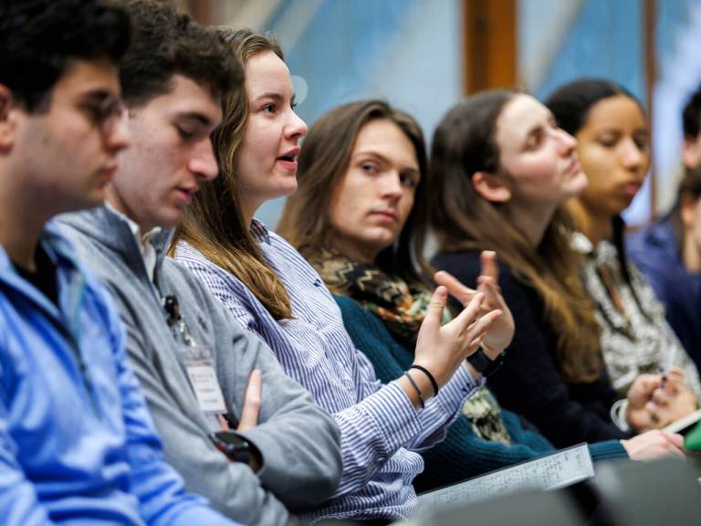 Harvard students in an audience asking questions