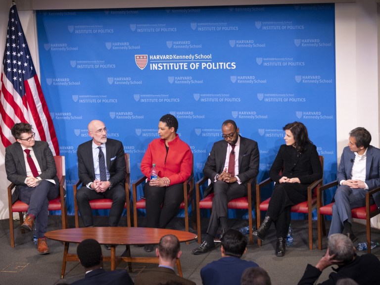 Harvard faculty talking on stage at a Harvard Kennedy event
